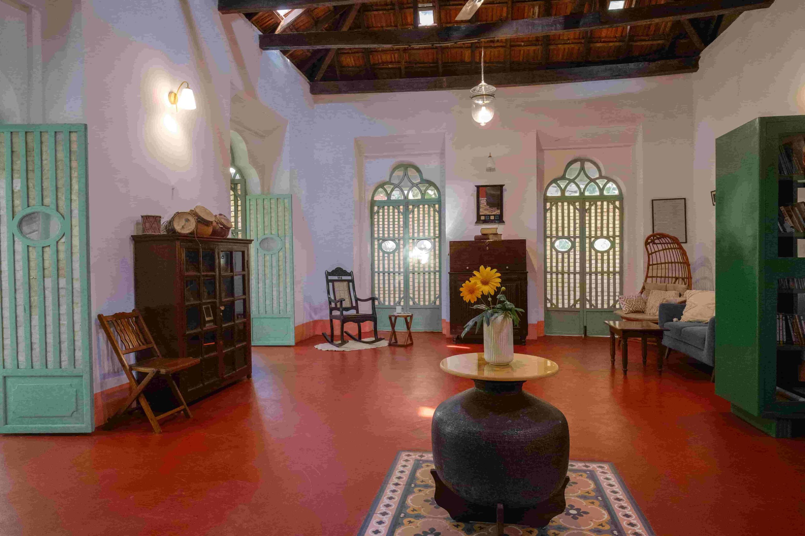 Interior hall of Quinta Verde with green heritage shutter doors and antique bookshelves